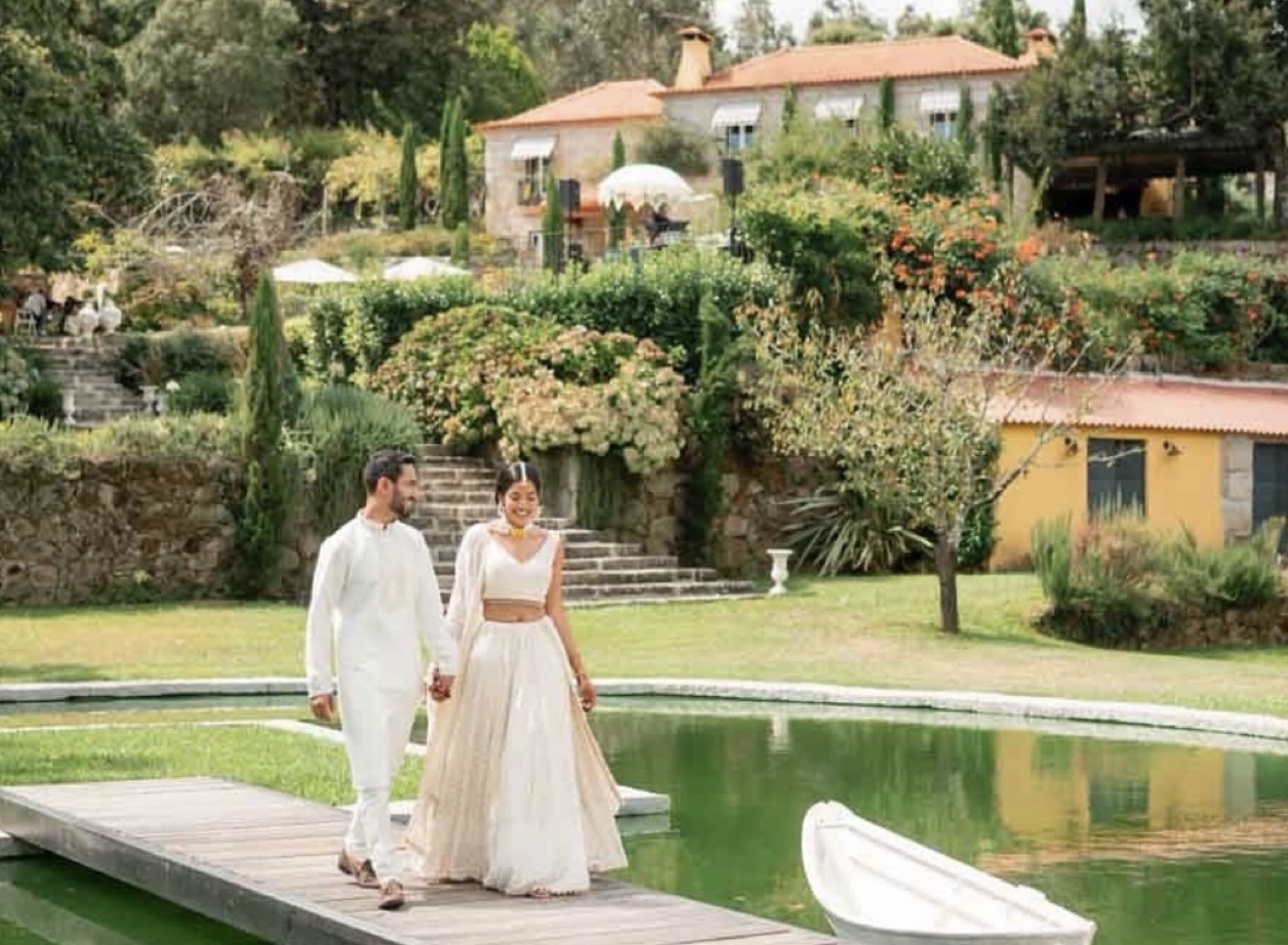 Bride and groom walking beside lake at Luxury Portugal destination wedding