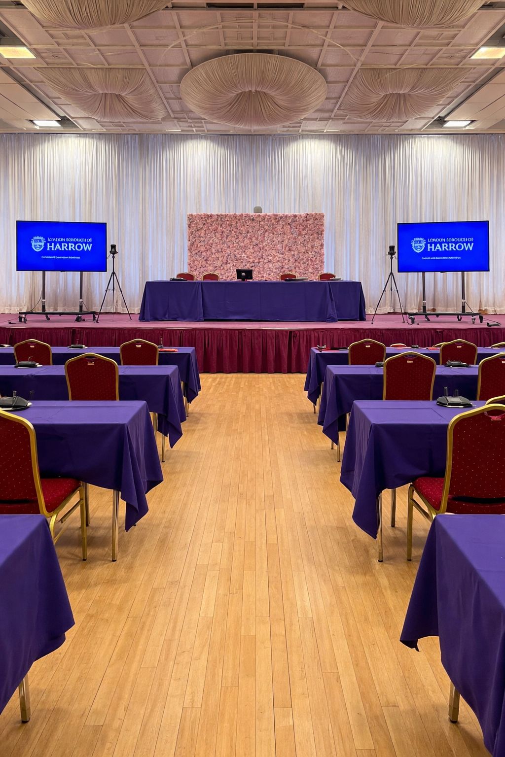 CORPORATE EVENTS Corporate conference stage setup with microphones. plasma screens and AV production by AK Musik London