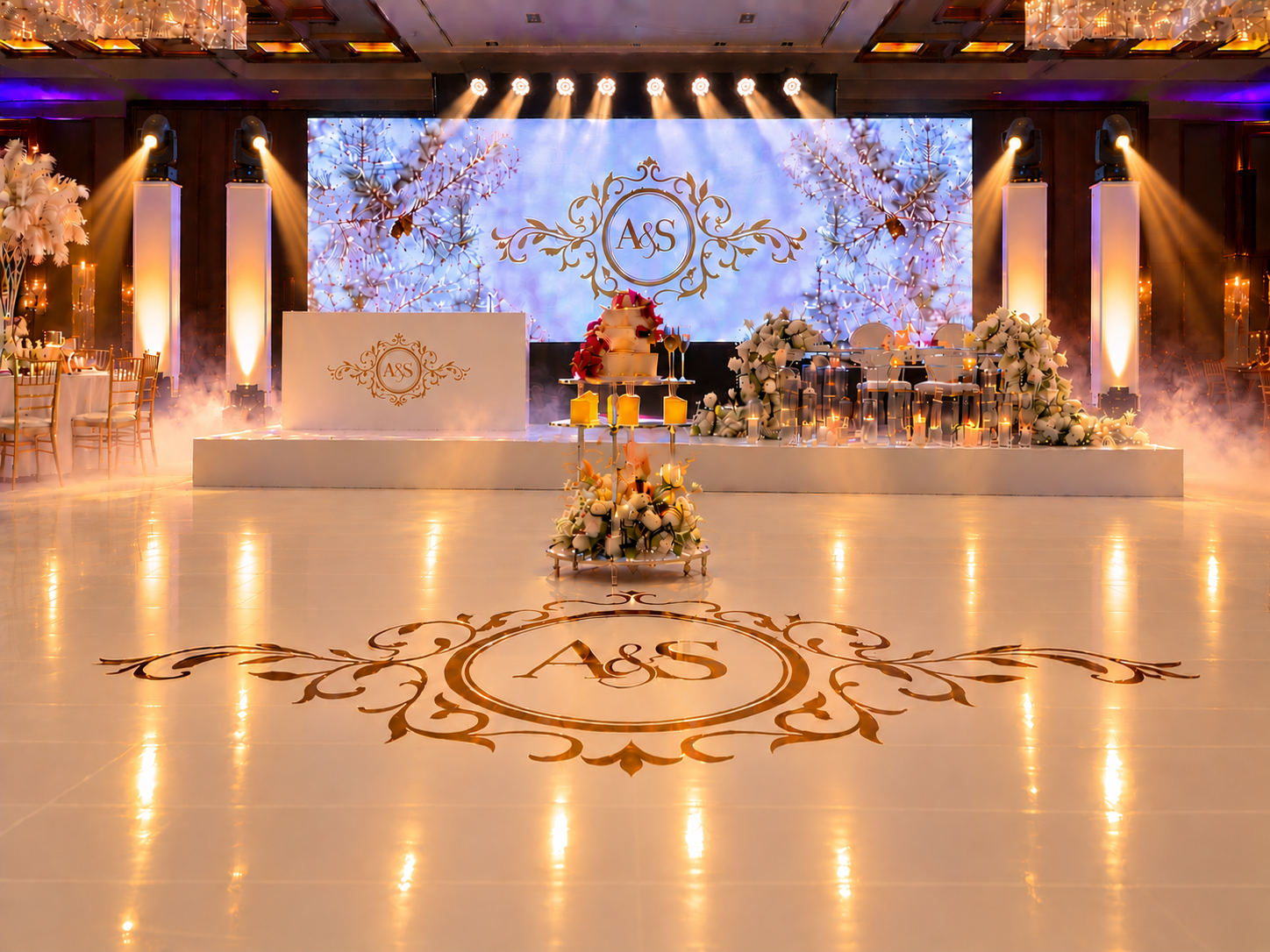 Luxury Asian wedding DJ setup with LED video wall, illuminated pillars, moving head lighting, haze, glossy white dancefloor and personalised A&S monogram